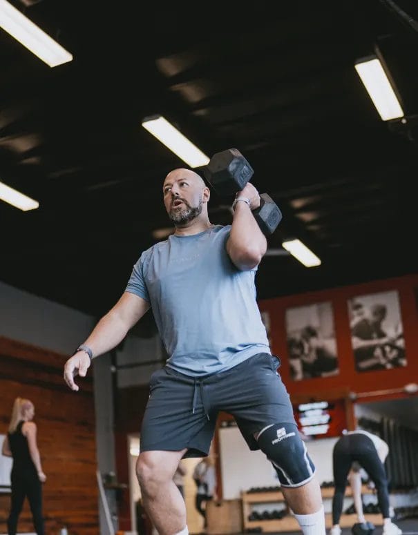 Man lifting dumbbell at Fortitude Fitness